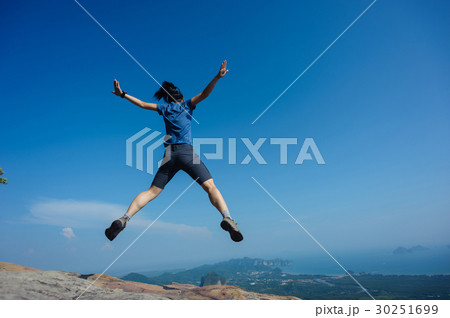 jumping on rocky mountain peak jumping on rocky mountain peak 30251699
