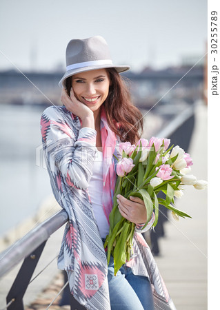 Beautiful young woman on bike in city street 30255789