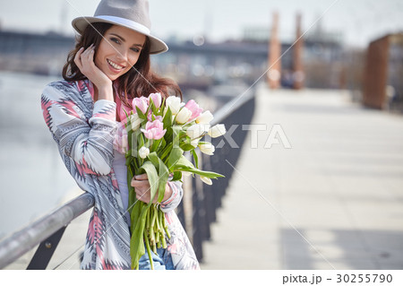 Beautiful young woman on bike in city street Beautiful young woman on bike in city street 30255790
