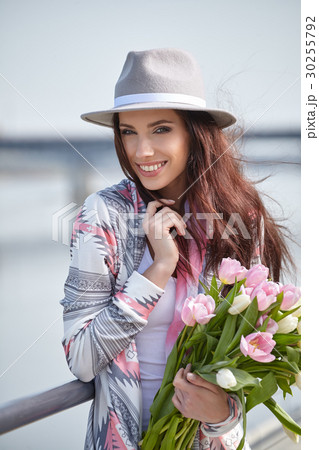 Beautiful young woman on bike in city street 30255792
