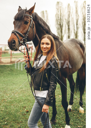 Beautiful girl communicates with a horse in the Beautiful girl communicates with a horse in the 30258624