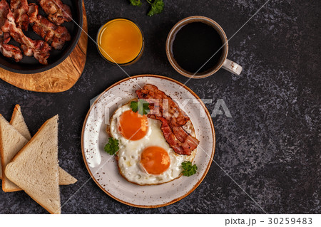 Breakfast with bacon , fried egg, coffee Breakfast with bacon , fried egg, coffee 30259483