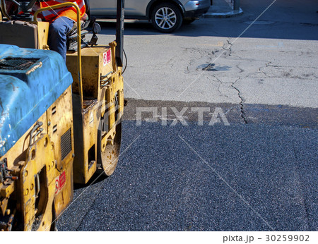 Worker on light vibration roller compactor asphalt Worker on light vibration roller compactor asphalt 30259902