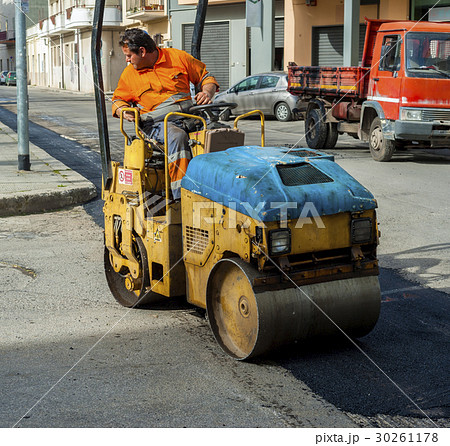 Worker on light vibration roller compactor Worker on light vibration roller compactor 30261178