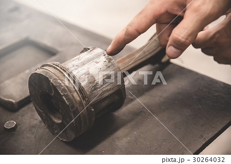 Close up a used old piston of car. Close up a used old piston of car. 30264032