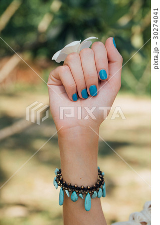White plumeria Flower on hand With a turquoise White plumeria Flower on hand With a turquoise 30274041