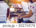 Close up of young girl is playing the guitar 30274579