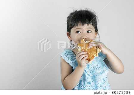Girl in Blue Thai Dress Eating a Hamburger. 30275583