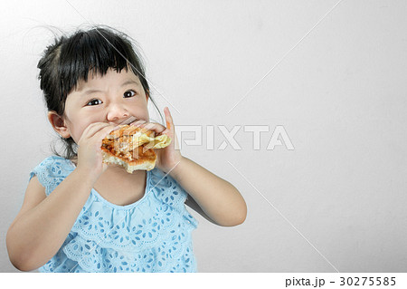 Girl in Blue Thai Dress Eating a Hamburger With intent fun. 30275585