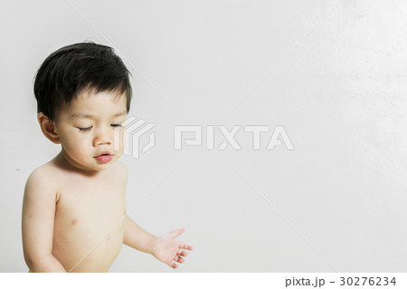 Baby Boy just wakes up and walks away with space for text. 30276234