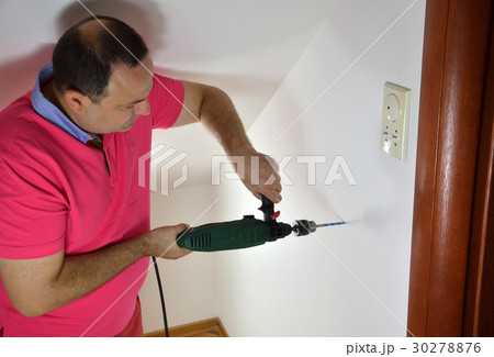 Man Drilling a Hole Man Drilling a Hole 30278876