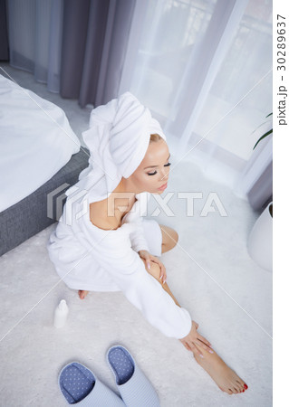 beautiful young woman wearing a towel and a white bathrobe and a 30289637