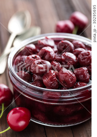 Berries cherry with syrup in a glass jar Berries cherry with syrup in a glass jar 30295695