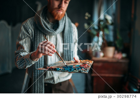 Artist paints colors on the palette, art studio 30298774