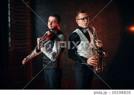 Saxophonist and violinst playing classical melody 30298820