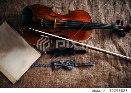 Violin, fiddlestick, notes and bowties closeup 30298823
