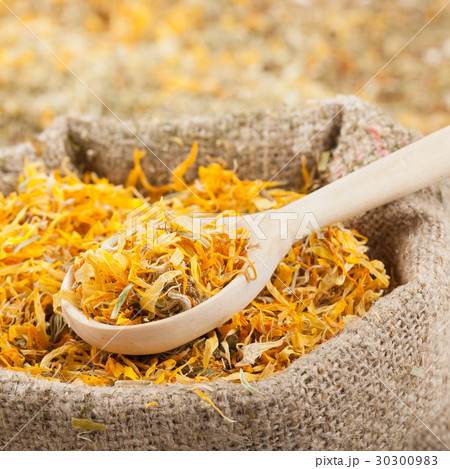 sack of healing herbs and wooden scoop 30300983