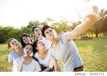 happy young group taking selfie in the park happy young group taking selfie in the park 30302723
