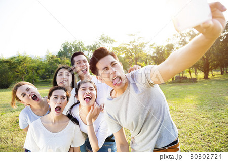 happy young group taking selfie in the park happy young group taking selfie in the park 30302724