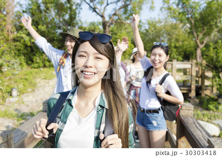 young group hiking together through the forest young group hiking together through the forest 30303418