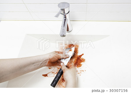 Wiping blood from a knife 30307156