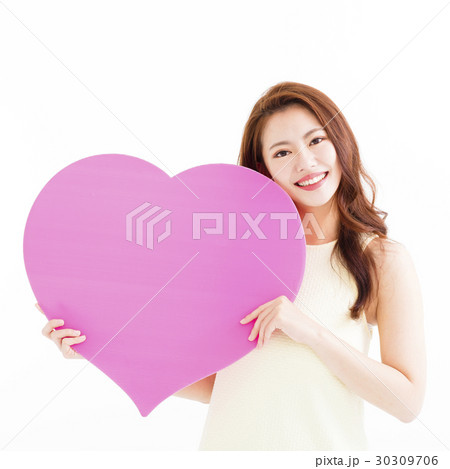 Beautiful woman in love and holding heart shape 30309706