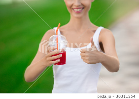 Young woman drink smoothie healthy detox outdoors 30311554