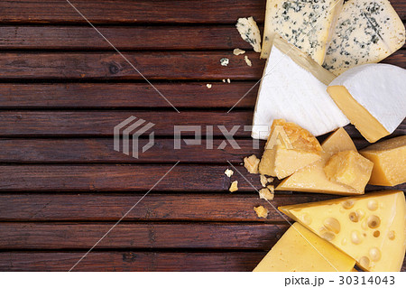 Various cheeses on wooden table with empty space. 30314043