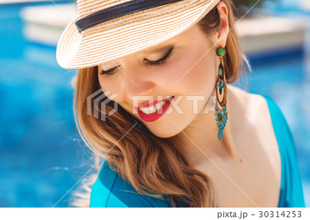 Fashion young woman near blue water 30314253
