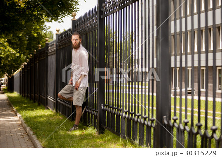 Bearded hipster outside in the city 30315229