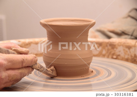 Hands of a potter, creating an earthen jar on Hands of a potter, creating an earthen jar on 30316381