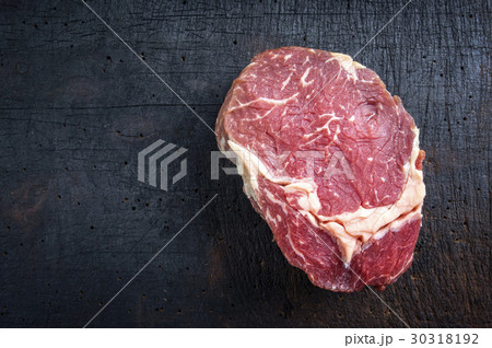 Dry Aged Raw Entrecote Steak on Cutting Board 30318192