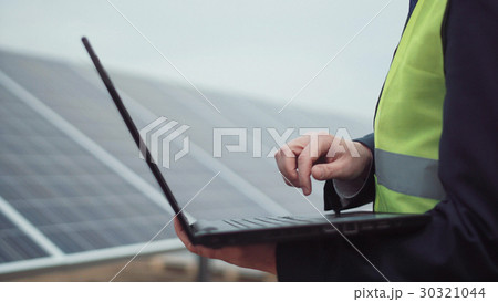 The worker with laptop on site 30321044