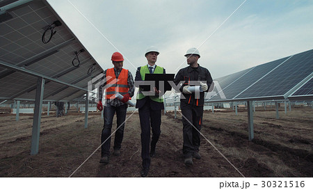 Engineers discuss building of a solar farm Engineers discuss building of a solar farm 30321516