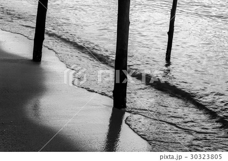 Wooden column at beach with sea background 30323805