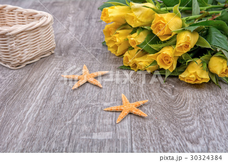 Orange starfishes and roses on a wooden background Orange starfishes and roses on a wooden background 30324384