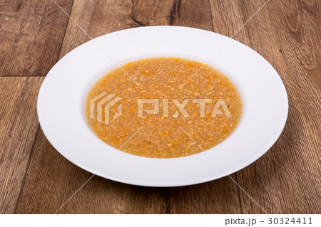 Vegetable soup on a wooden table Vegetable soup on a wooden table 30324411
