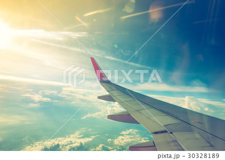 Wing of an airplane flying above the clouds .( Filtered image processed vintage effect. ) Wing of an airplane flying above the clouds .( Filtered image processed vintage effect. ) 30328189