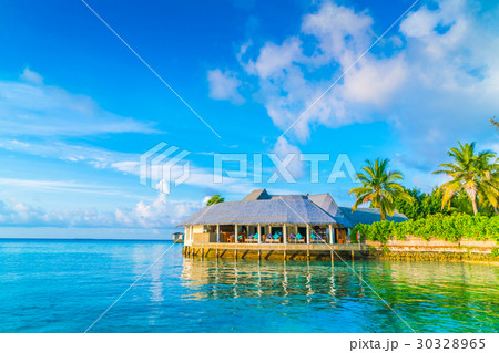 Beautiful water villas in tropical Maldives island at the sunrise time . Beautiful water villas in tropical Maldives island at the sunrise time . 30328965