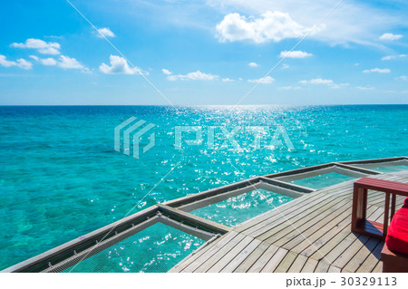 Vacation net seat in tropical Maldives island and beauty of the sea with the coral reefs . Vacation net seat in tropical Maldives island and beauty of the sea with the coral reefs . 30329113