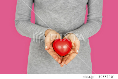 Gentle girl holding a res heart Gentle girl holding a res heart 30331101