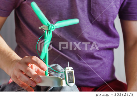man with solar panel windmill man with solar panel windmill 30332278