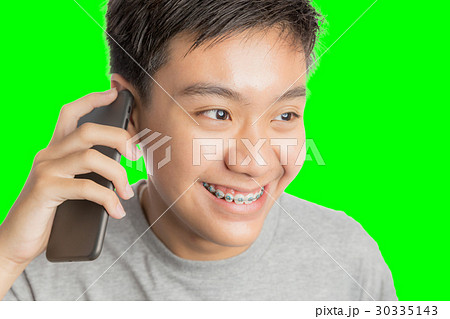 Young man smiling and happy use smartphone.  30335143