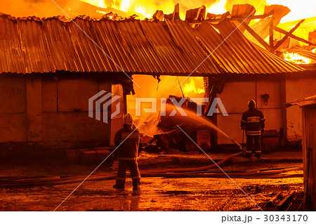 Firefighters extinguish a fire 30343170