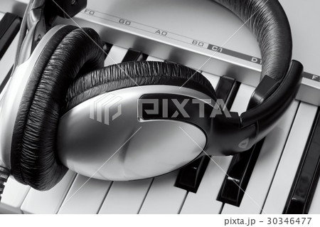 Headphones on synthesizer keyboard 30346477
