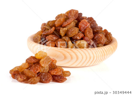 raisins in a wooden bowl isolated on white 30349444