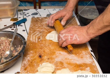 man prepares dumplings at home man prepares dumplings at home 30351032