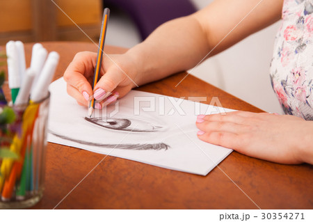 Closeup of drawing human eye at the desk 30354271