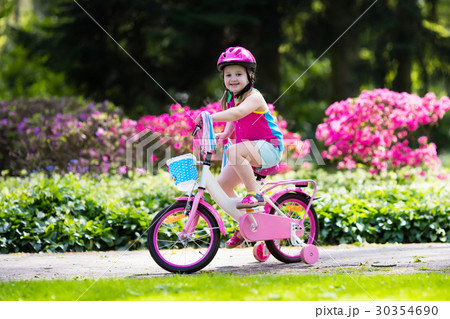 Child riding bike. Kid on bicycle. 30354690