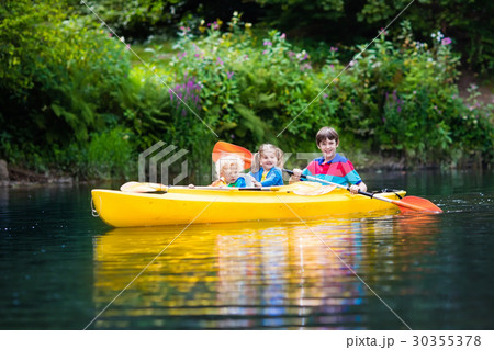 Kids kayaking on a river 30355378